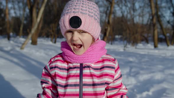 Child Girl Opening Her Mouth in Amazement Wow Delight Gesture Pleasantly Surprise in Winter Park alt