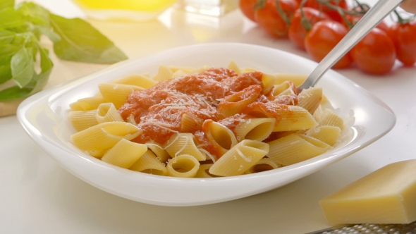 Hot Pasta With Tomato Sauce, Parmesan Cheese And Basil On a Spoon