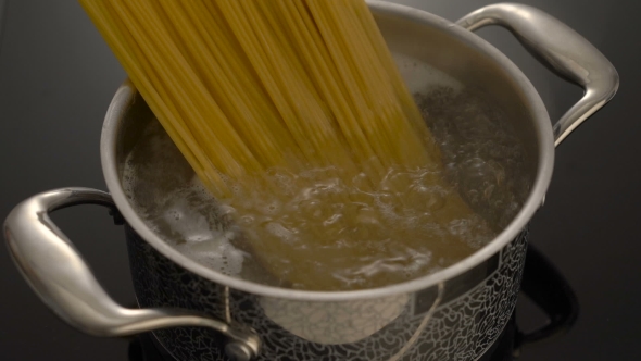 Boiling Spaghetti In Pan On Electric Stove In The Kitchen