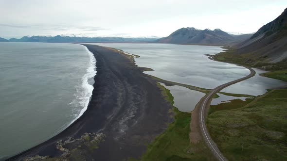 Drone Over Landscape With Road And Black Beach Near Estrahorn Mountain alt