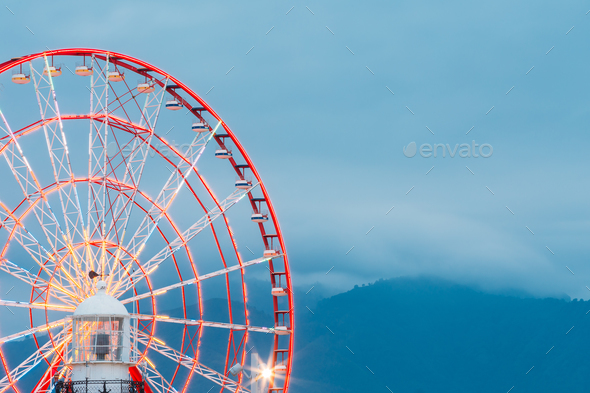 Batumi Georgia. Close View Of Ferris Wheel And Top Of White Ligh - Stock Photo - Images
