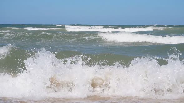 Sea Waves on a Sandy Beach on a Sunny Summer Day. Slow-motion Video alt