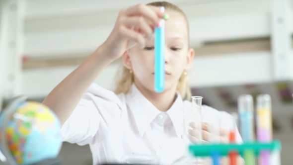 Girl Holding Flask With Blue Chemical Solution