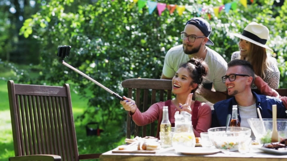 Friends Taking Selfie At Party In Summer Garden alt