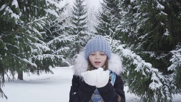 Portrait of a Happy Blueeyed Teenage Girl in a Snowy Park alt