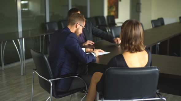 Male Realtor With Key And Young Couple From Back. alt