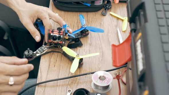 Man Assembling FPV Drone Using Tools
