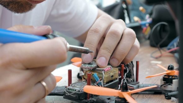 Man's Hands Welding Details Assembling FPV Drone
