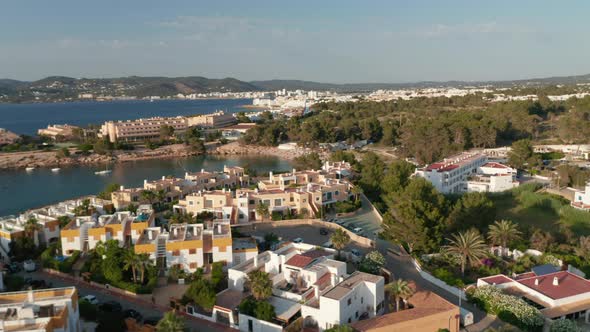 Aerial Circular Motion View of Rooftop of Beautiful Houses Near the Beach and Shore with Boats and alt