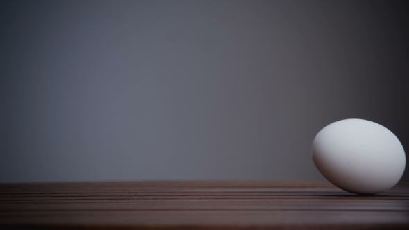 An Egg Is Rolling Across The Table. .