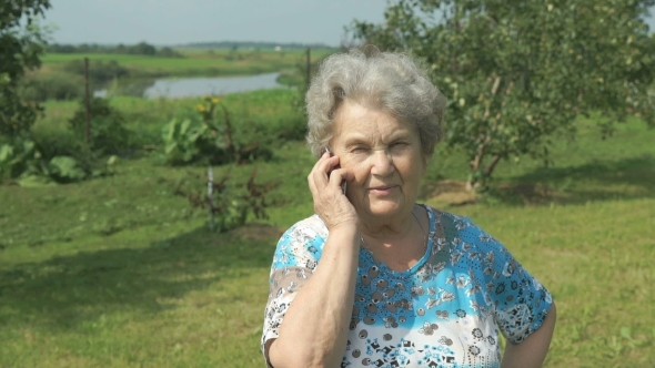 Elderly Woman 80s Communicates Cell Phone Outdoors
