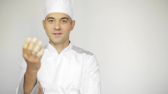 Male Chef In a Commercial Kitchen Standing On The White Background