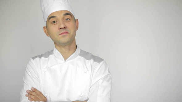 Male Chef In a Commercial Kitchen Standing On The White Background