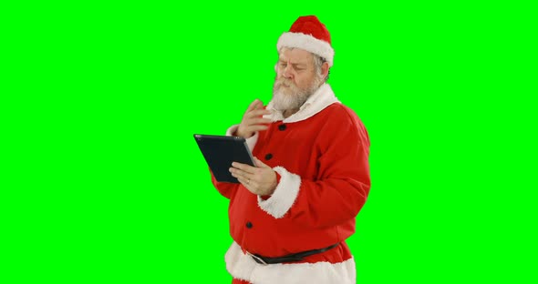 Santa claus using digital tablet alt