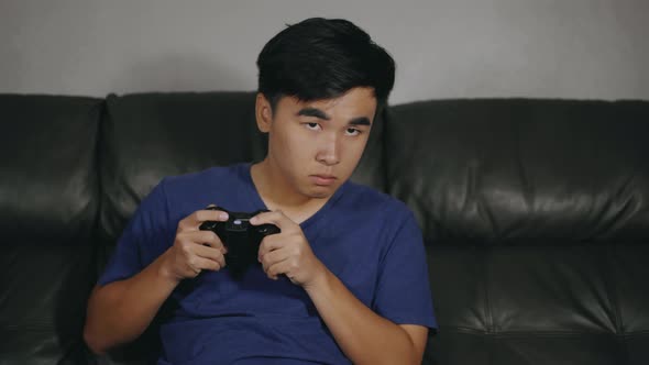 young man playing video games and wins at night