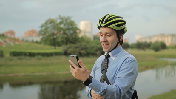 Businessman With Helmet And Smartphone