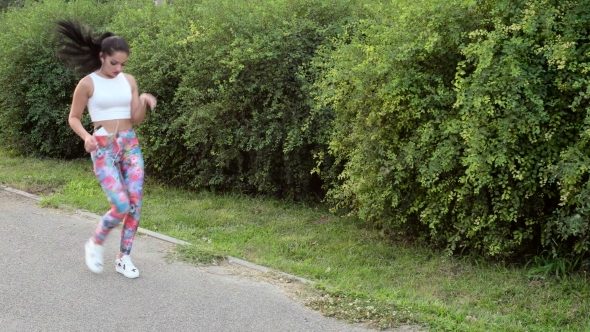 Woman Tying Shoes While Running