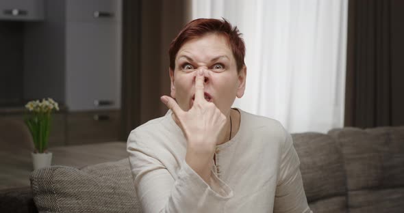 Woman Grimaces Shows Tongue Twists Nose Gestures Hands Twists Grimaces Emotional Actress Sitting on alt