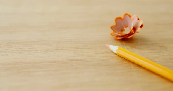 Close-up of yellow colored pencil with shavings alt