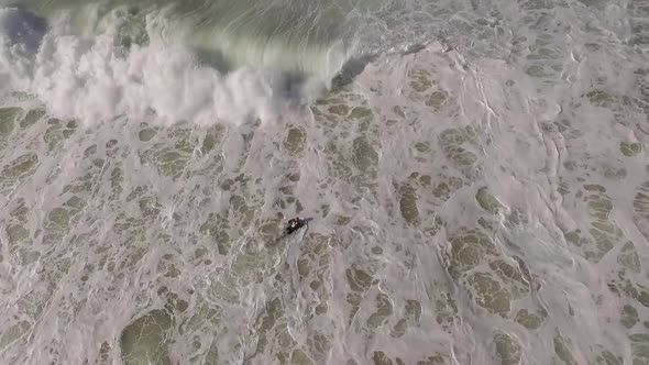 Surfer Struggling in Waves