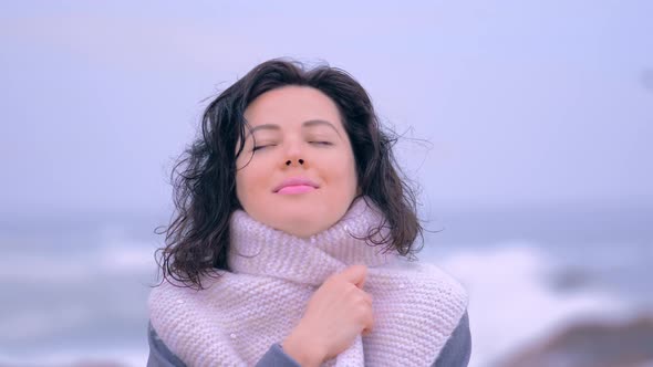 Portrait of Stylish Female in White Scarf Warming Hands