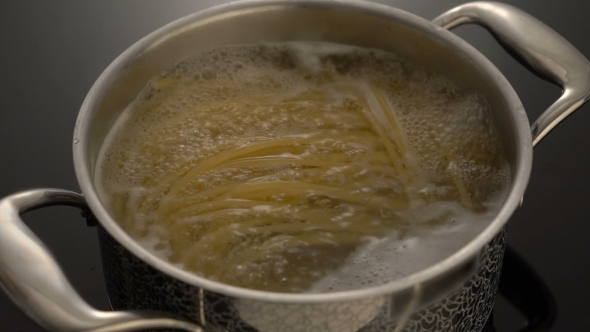 Cooking Spaghetti In Boiling Water On Electric Stove