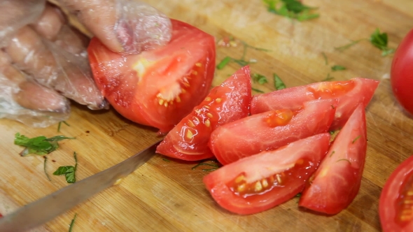 Hands Cut Tomatoes For Salad