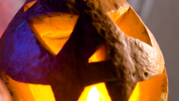 Pumpkin Head Lit From Within, Her Eyes, Nose And Mouth Flickering Candle Light. All Saints Day alt