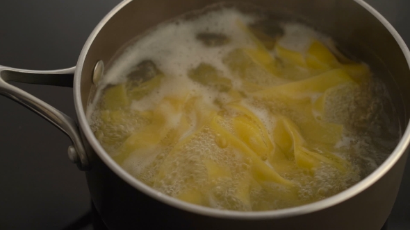 Pasta Boiling In a Pot On Electric Stove