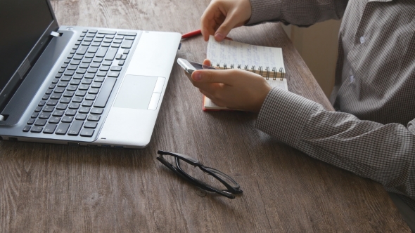 Man Working On Computer At Wooden Desk alt