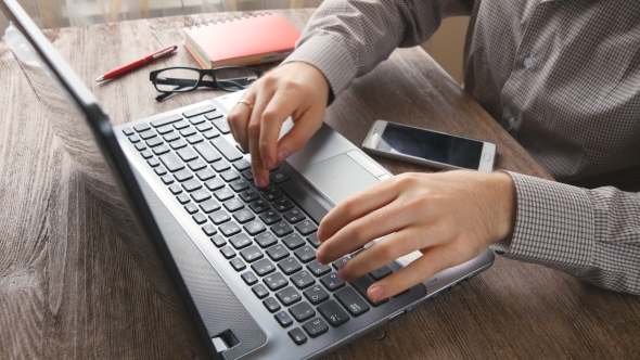 Man Arms Typing On Keyboard At Natural Hardwood Desk alt