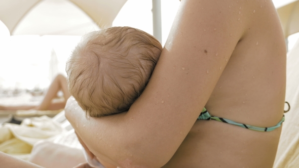 A Mother Is Breastfeeding Her Newborn Child