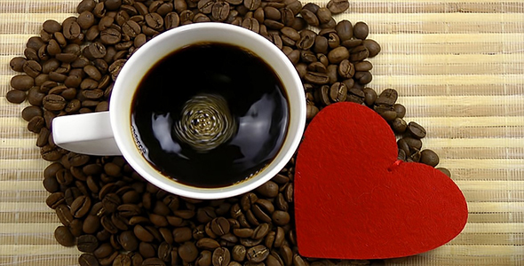 Cup of Coffee and Red Heart on Coffee Beans