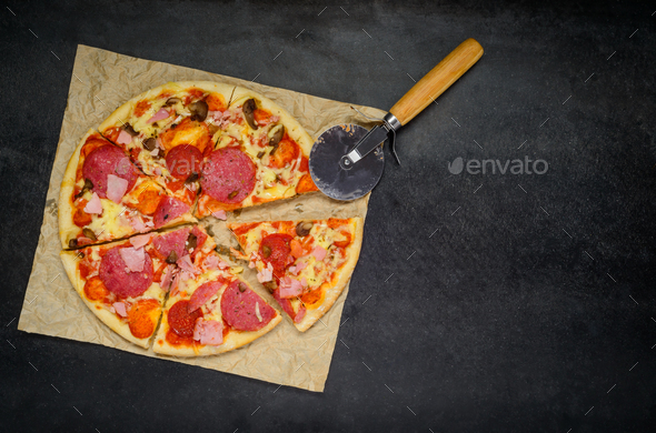Sliced Pizza with Pizza-Cutter on Copy Space Area