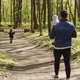Little Happy Girl Running On A Path In The Woods, Dad With A Child In His Arms Catches Up With Her - VideoHive Item for Sale