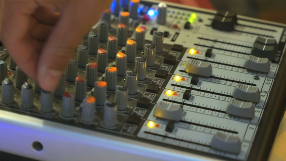 DJ Working on a Audiomixer at a Nightclub
