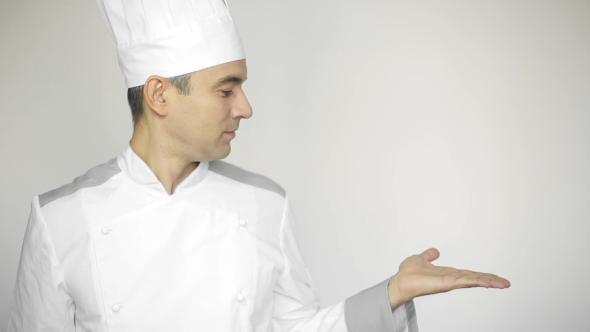 Male Chef In a Commercial Kitchen Standing On The White Background