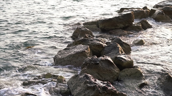 Waves Breaking Against Rocks On Sea Shoreline.