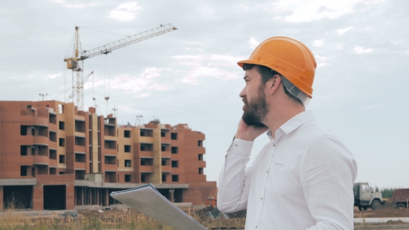 Architect Talking On Cell Phone On a Construction Site alt