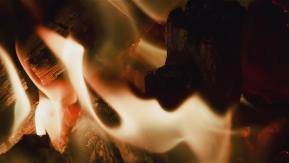 Hot Fireplace Full Of Wood And Fire. Black Background. alt