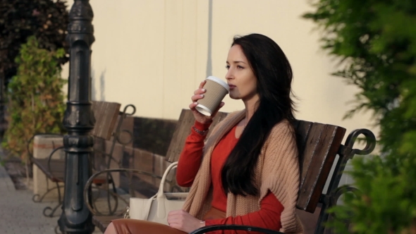 Girl Drinking Coffee In The Park