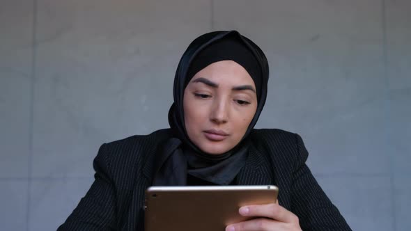 Muslim Bussinesswoman Holding Digital Tablet and Working Professional Plan Research and Analysis