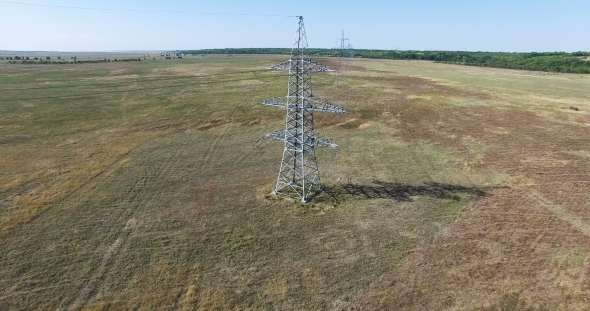 AERIAL: Flying Up The High Voltage Electricity Tower And Power Lines. Aerial