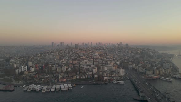 Aerial shot of Galata Bridge and boats at sunrise
