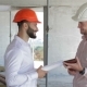 Two Builders Looking At The Digital Tablet At The Building Under Construction - VideoHive Item for Sale
