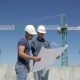 Construction Manager Points At The Plan Of Building Under Construction - VideoHive Item for Sale