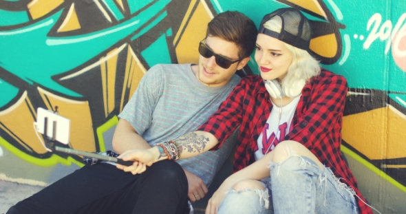 Trendy Young Hipster Couple Taking a Selfie alt