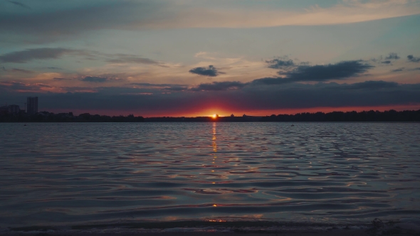 Sunset Over The Water. Interesting Unusual Light.