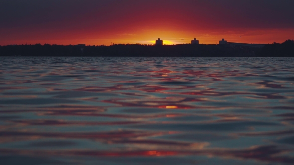 Sunset Over The Water. Interesting Unusual Light.