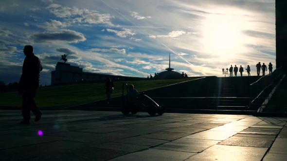 Silhouettes Of People Walking Upstairs And Downstairs Against Evening Sky.  Shot alt